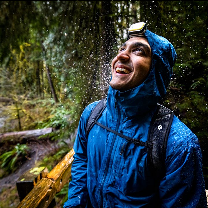 A hiker wearing a Black Diamond Rain Jacket in Olympic National Forest | Rainwear