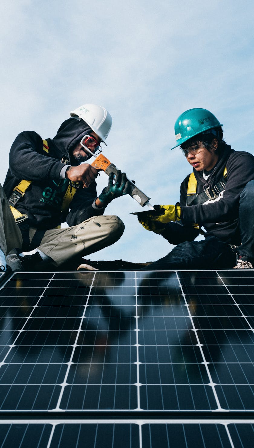 Two men working on solar units