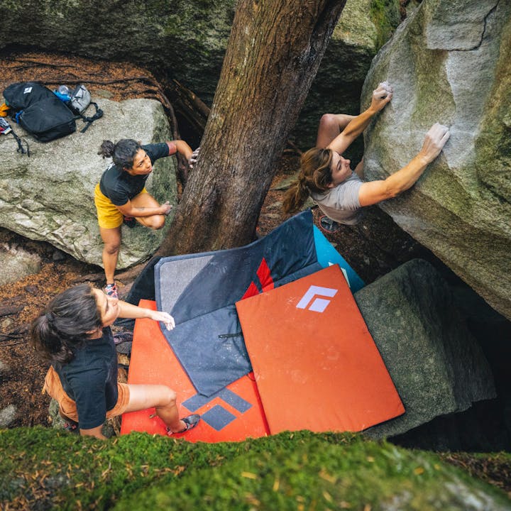 BD athlete Collette McInerney is spotted by her friends while bouldering. 