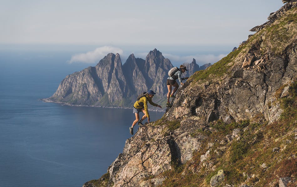 Hillary Gerardi and Kyle Richardson scramble up a mountain face in Norway