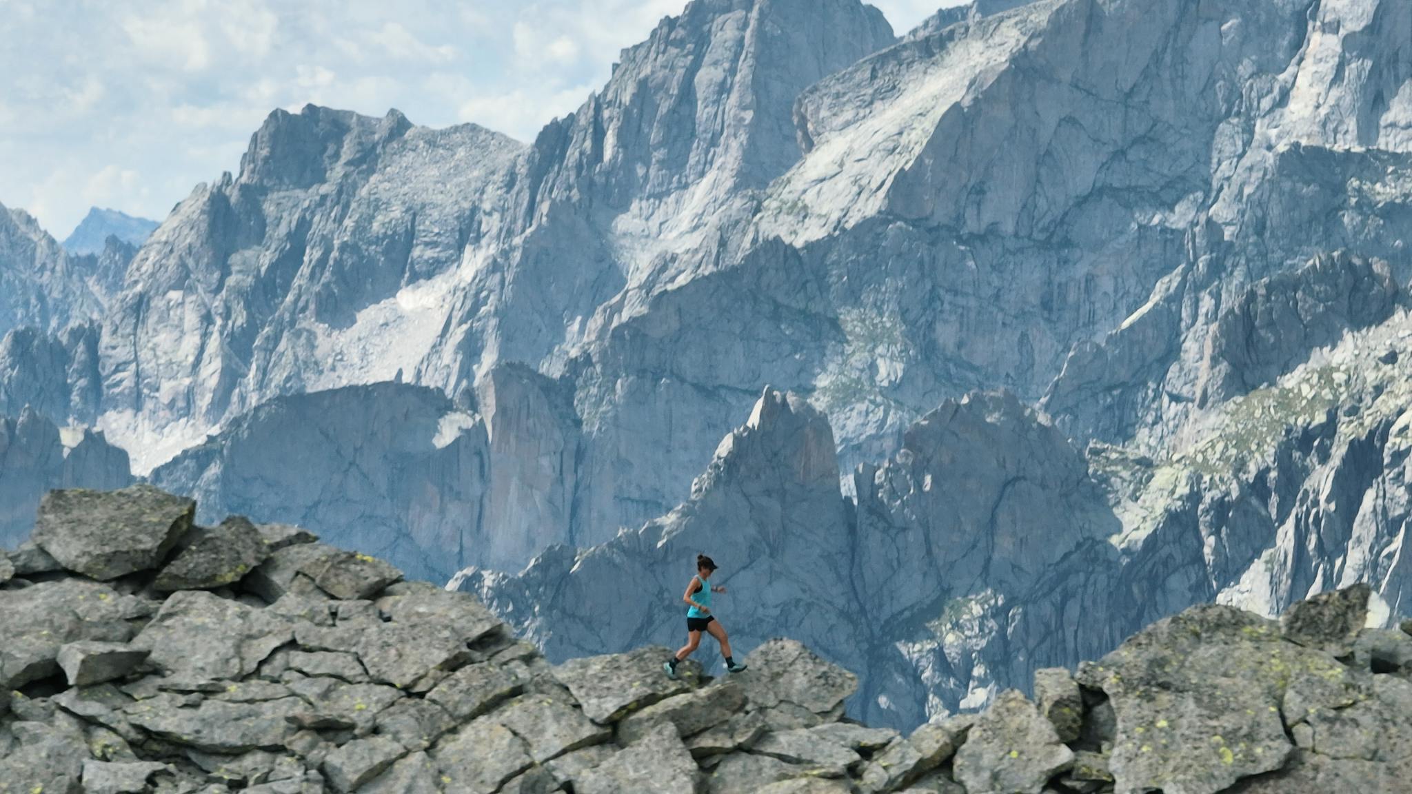 Black Diamond athlete Hillary Gerardi running across a skyline ridge line. 
