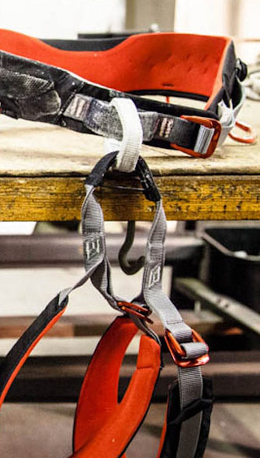 multiple harnesses hanging off a work bench