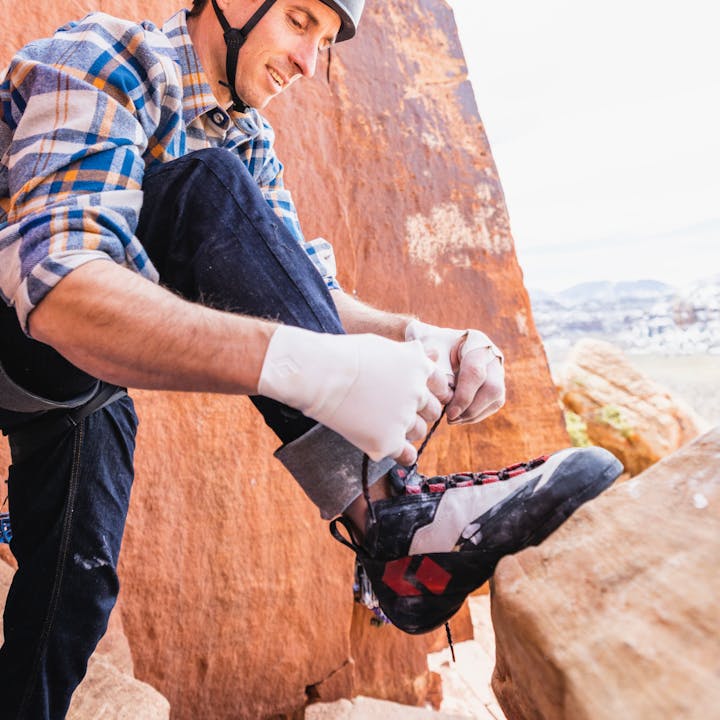 BD athlete Carlo Traversi laces up Black Diamond Aspect Pro climbing shoes.